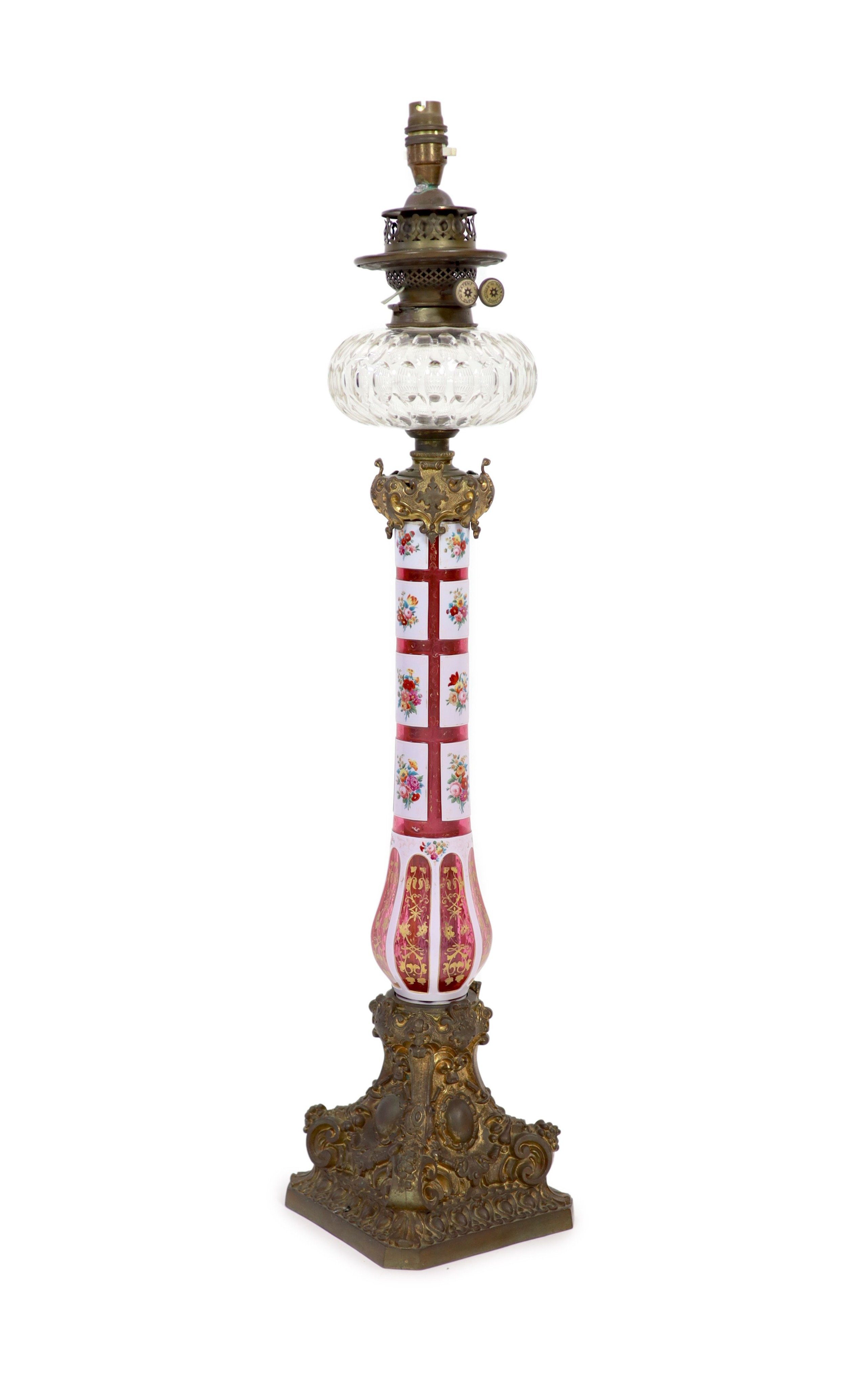 A Victorian ormolu mounted Bohemian ruby overlaid glass oil lamp, height 79cm